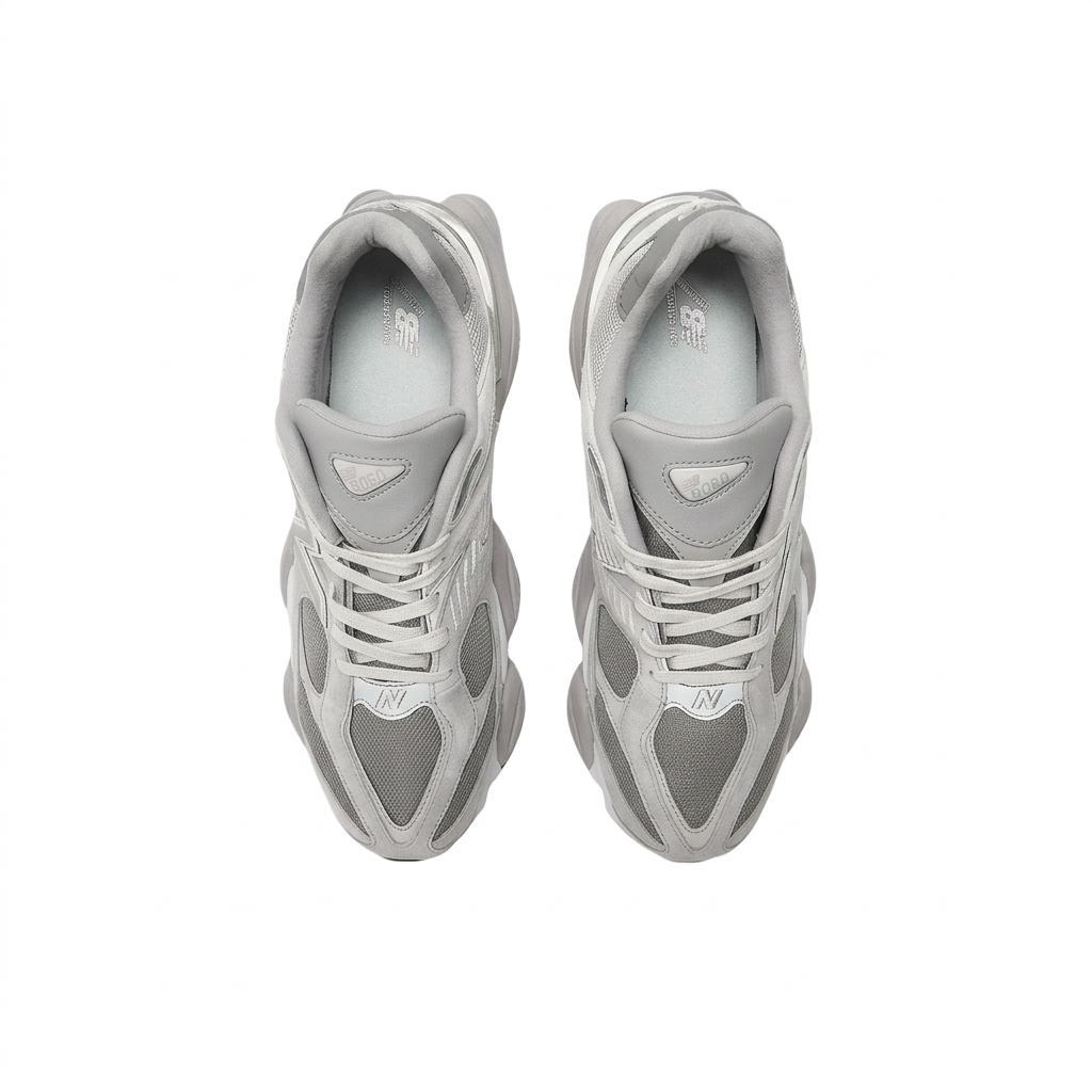 New Balance 9060 grey and white sneakers, top view on white