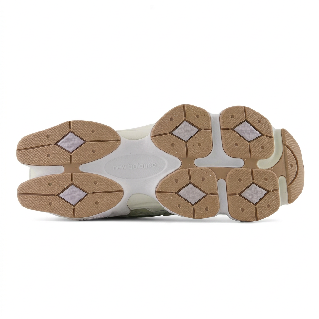 New Balance 9060 gum-brown segmented outsole with six white diamond inserts on white background