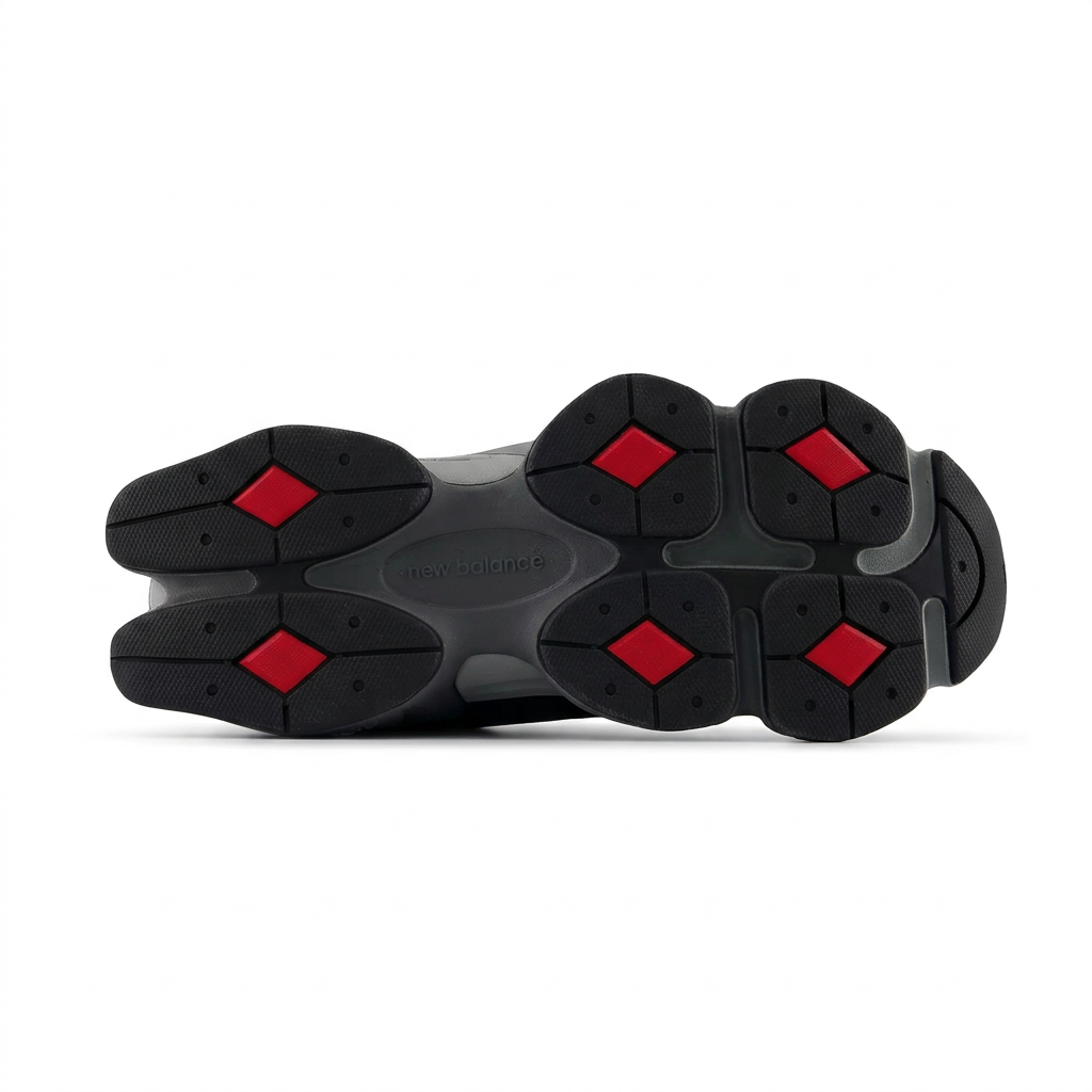 New Balance 9060 black and grey outsole with red diamond inserts on white background
