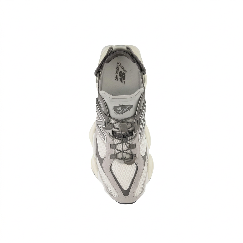 New Balance 9060 grey and cream sneaker with cord-and-toggle lacing, top view on white