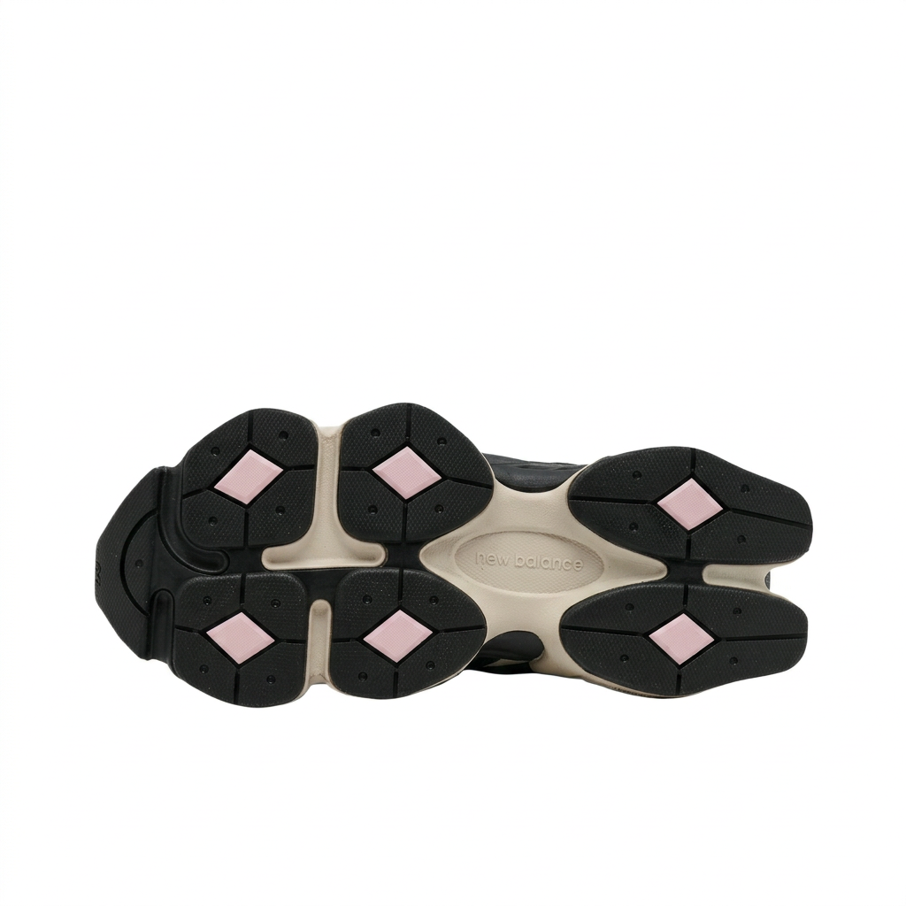 New Balance 9060 outsole with black tread, cream channels and six pale pink diamond inserts on white background